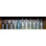 11 clear glass mineral bottles of Irish Interest (top shelf) – Waterford, Kilkenny, Tullamore,