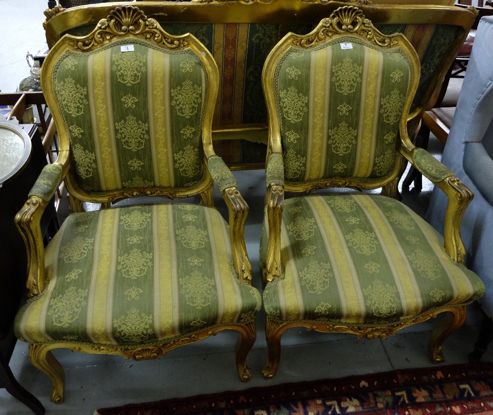 Matching Pair of Gilt Framed Armchairs, the carved top rails decorated with stylized flowers and