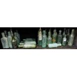 Large Shelf of antique glass mineral water etc bottles, mainly English brands, some with round