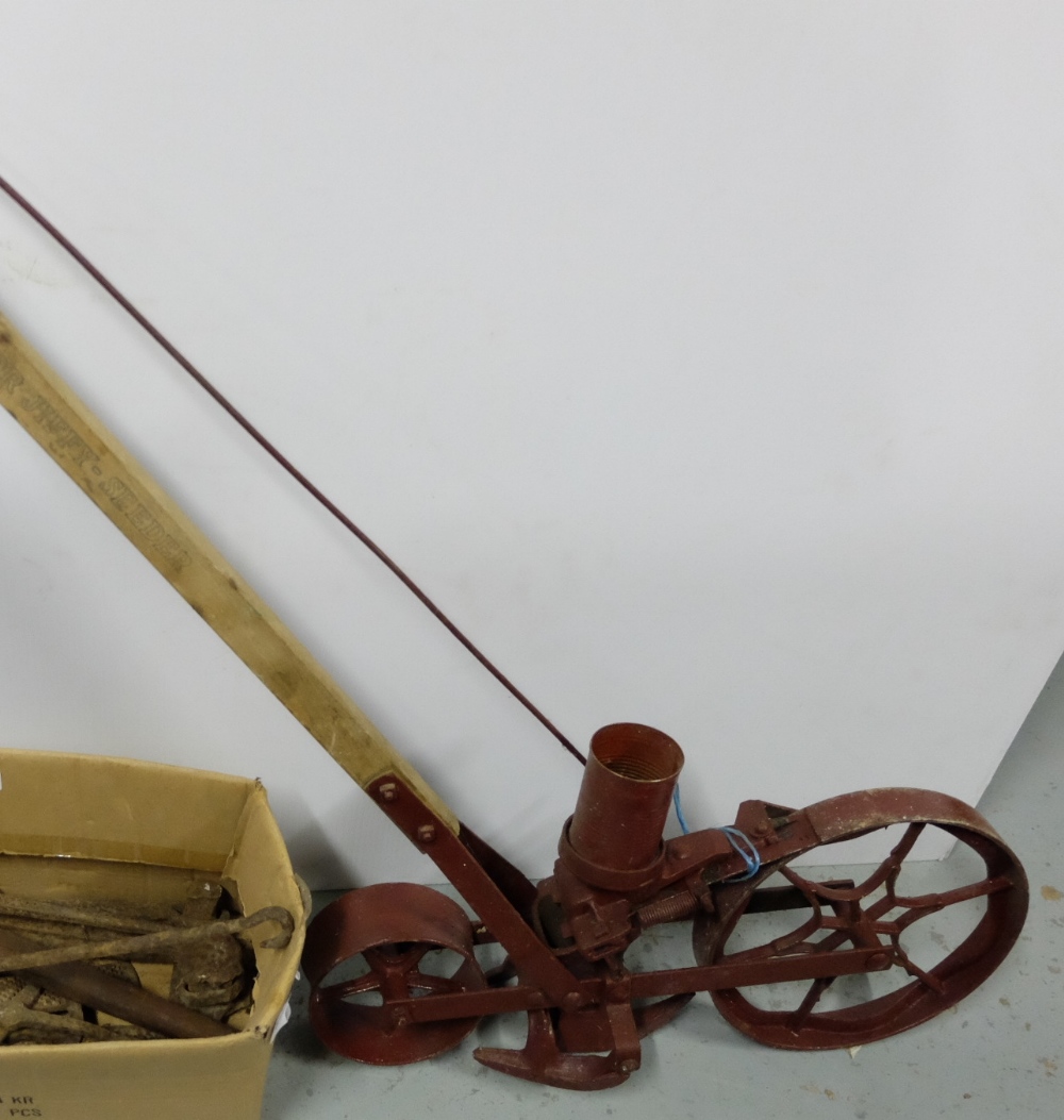 Metal Garden Seeder, with single wheel, painted red with wooden handle