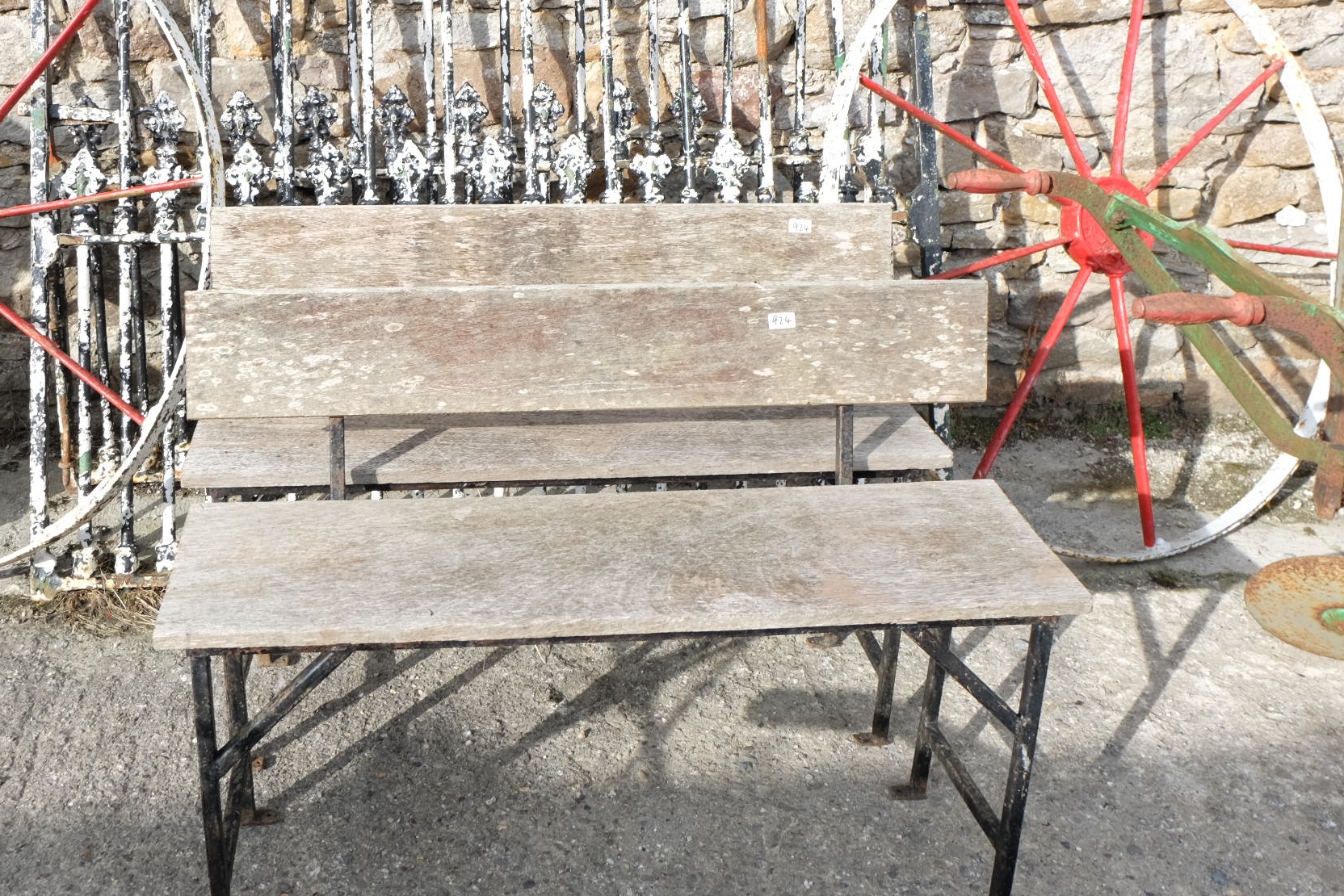 Pair of garden seats with timber backs and seats, on an iron base (2)