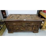 Carved Camphor Wood Oriental Chest, decorated in relief on all sides and top with Justice Scenes,