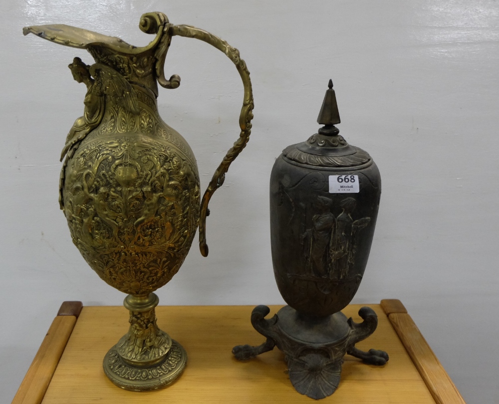 19thC plated Urn with pointed lid, (lined interior) the front panel decorated in relief with Roman