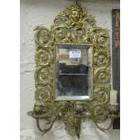 Pierced brass framed wall mirror, with candle scones, decorated with swirls and figures of Roman