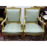 Matching Pair of Carved Gilt Empire Style Armchairs, the padded backs and seats covered with blue