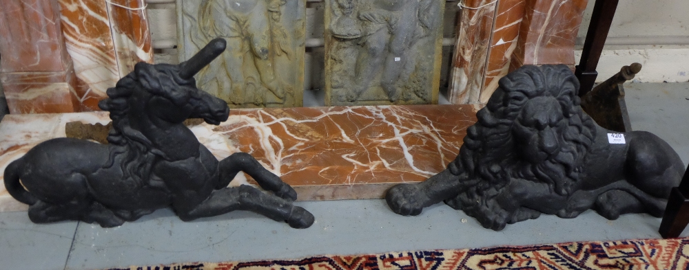 Similar Pair of Cast Iron Fire Dogs - one in the form of a Lion (28”w x 15”h) & one a seated