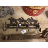 Cast iron coat hanger in the form of Racing Horses.