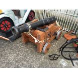 Cast iron cannon on wooden base.