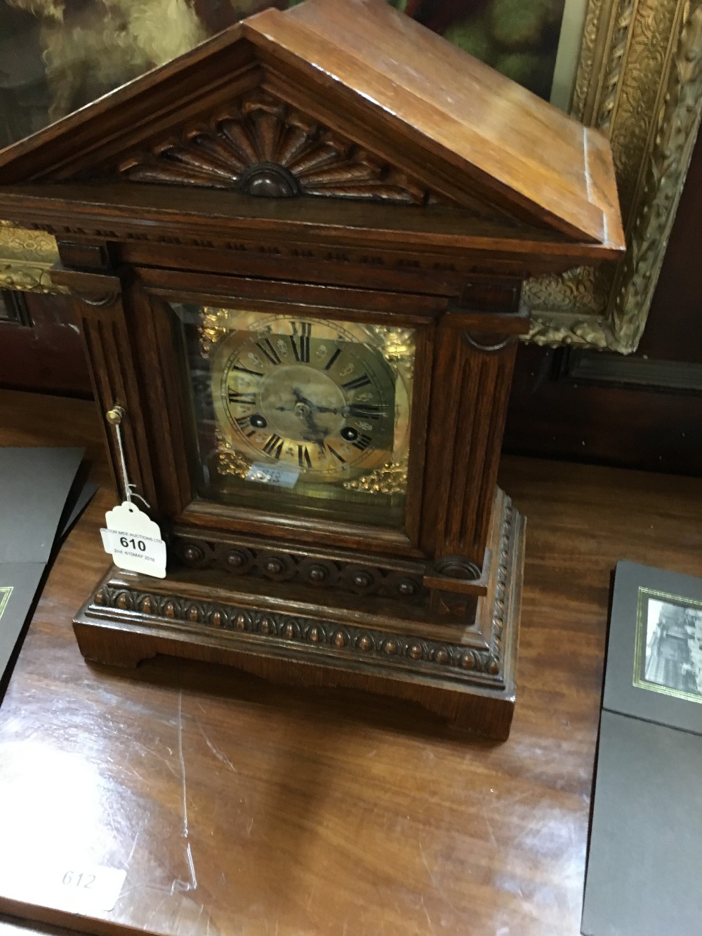 Victorian oak mantle clock with brass dial.