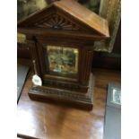 Victorian oak mantle clock with brass dial.