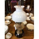 Victorian oil lamp with brass stem ceramic bowl and mushroom shade.