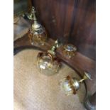 Collection of four clear glass lamp shades overlaid with amber glass.