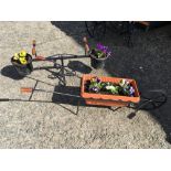 Wheel barrow and see saw flower display.