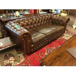 20th. C. buuton backed leather upholstered three seater chesterfield couch.