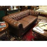 20th. C. button backed leather upholstered three seater chesterfield couch.