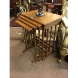 Nest of four Edwardian walnut tables.