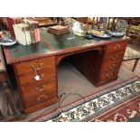 Mahogany knee hole writing desk with eight graduating drawers.