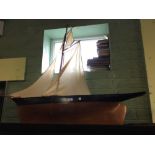 Large wooden model of a yacht.