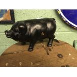 Cast iron money bank in the form of a pig.