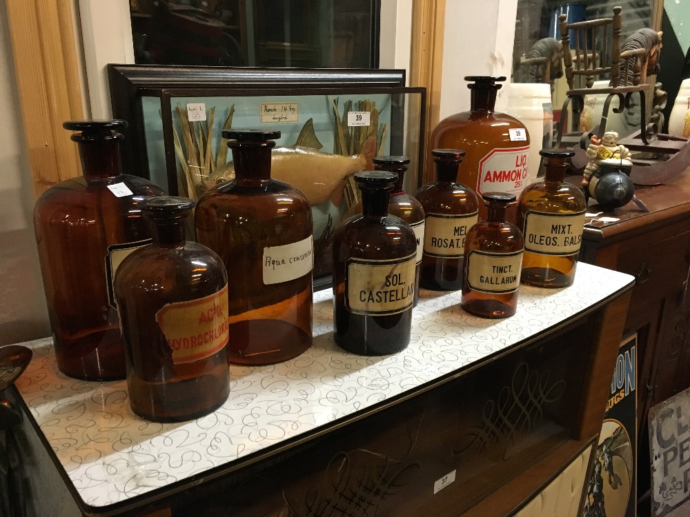 Nine brwon glass chemist's bottles.