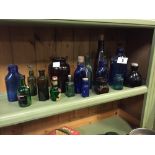 Collection of blue and green bottles.