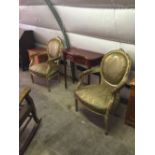 Pair of carved gilt wood arm chairs.