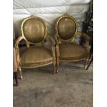 Pair of carved gilt wood arm chairs.