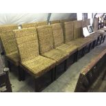 Set of sixteen wicker dining room chairs.