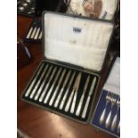 Cased set of 12 English silver knives.