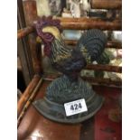 Cast iron model of a rooster.