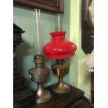 Brass Aladdin lamp with red shade and another.