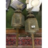 Pair of brass trap lamps.