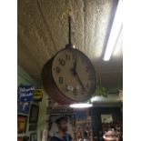 Large round faced railway station clock.