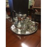 Silver plate tray with tea pot, coffee pot, creamer and sugar bowl.