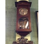 Edwardian mahogany wall clock with silver dial.