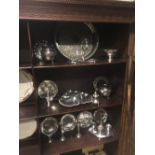 Three shelves of miscellaneous silver plate.