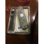 Silver photo frame, brush and comb set.