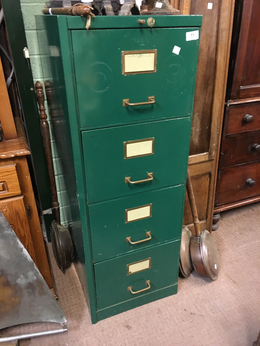 Four drawer metal filing cabinet with key.