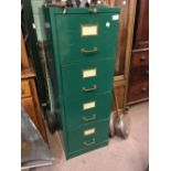 Four drawer metal filing cabinet with key.