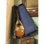 Cased mandolin.