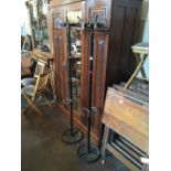 Three metal coat stands.