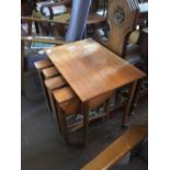 Nest of miniture drop leaf tables.