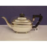 HM SHEFFIELD SILVER TEAPOT WITH EBONISED HANDLE AND FINIAL ON BUN FEET BY GEORGE HOWSON, DATED 1925.