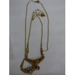 TWO INDISTINCTLY MARKED YELLOW METAL EASTERN STYLE NECKLACES WITH IMITATION STONES