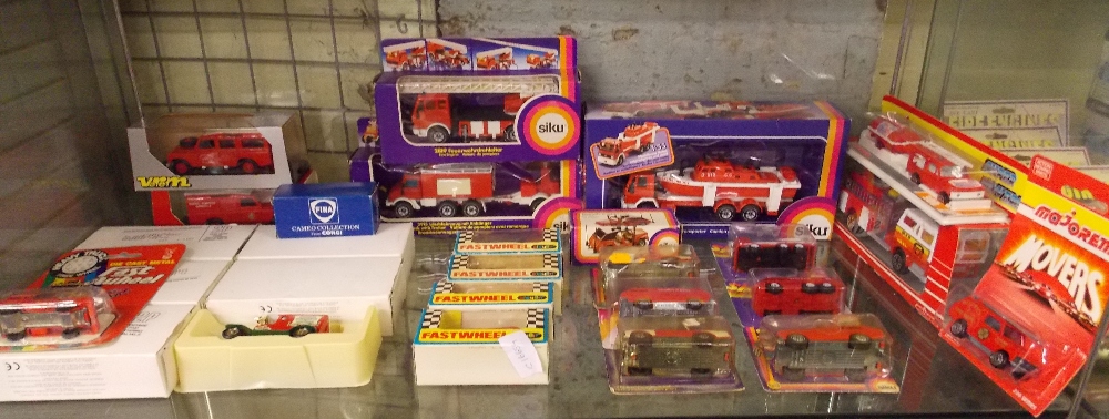 SHELF OF MINT AND BOXED MISCELLANEOUS FIRE ENGINES AND TRUCKS BY SIKU, MAJORETTE, PLAYART,