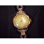 LADIES 9CT GOLD WRIST WATCH ON LEATHER STRAP