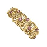 18K YELLOW GOLD BRACELET set with 84 full cut rubies (approx. 1.20ct.t.w.) and 14 small single cut