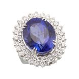 18K WHITE GOLD COCKTAIL RING set with a fine, large oval cut tanzanite (approx. 24.0ct.) encircled