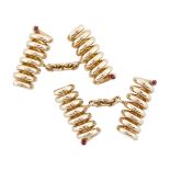 PAIR OF ENGLISH 18K ROSE GOLD CUFFLINKS formed as coiled springs and set with small ruby