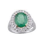 18K WHITE AND YELLOW GOLD FILIGREE RING set with an oval cut emerald (approx. 3.07ct.) in a mount